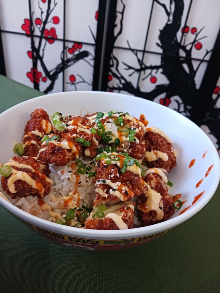 Panko fried chicken bites over your choice of ric